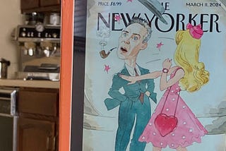 Author photo of iPad shown from kitchen table with image The New Yorker “Slappenheimer” cartoon cover of Barbie slapping Oppenheimer, knocking his pipe out of his mouth, and sending his hat flying off his head.