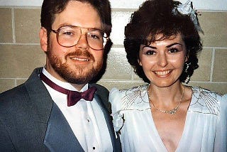 Color wedding photo of a couple in a church basement.