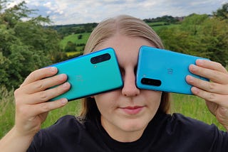 Sophie holding the OnePlus Nords devices over her eyes.