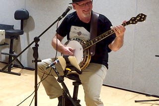 The author singing and playing banjo on stage