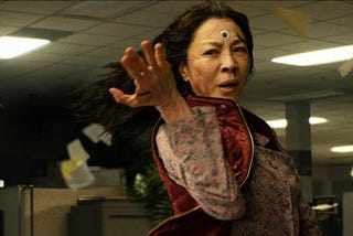 Still of Michelle Yeoh as Evelyn Wang in 2022’s Everything Everywhere All At Once, creating a tailspin in the IRS office