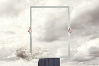 Capton: Surreal moment of a woman hiding behind a picture of clouds equal to the landscape. Credit: fcscafeine/iStock.com