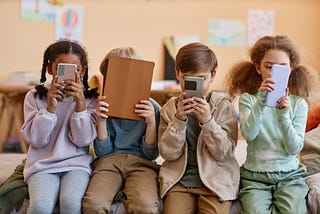 children looking at phones