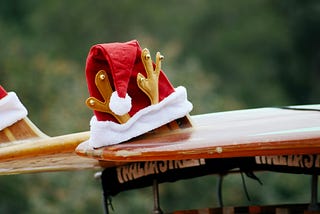 A Santa hat on a surf board illustrating the experience of Christmas in New Zealand.