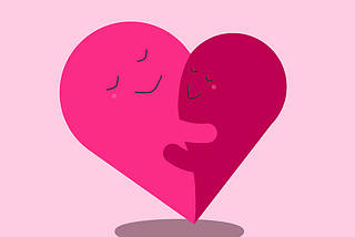 Two pink hearts smiling and hugging each other to show the importance of having compassion towards your anxiety