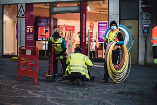 Technicians installing empty pipes for fast fiber internet