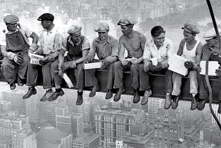 Eleven iron workers sitting 60 floors above New York City on a steel girder
