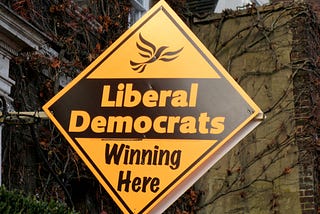 An Orange Liberal Democrats campaign sign in St Albans England saying Winning Here on a residential house