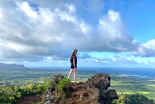 A photo of Sammy on top of a hike in Kauai overlooking the ocean