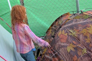 young girl entering her family’s tent