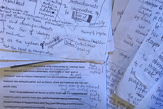 Papers with typed words, handwriting in margins.