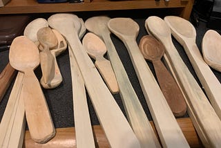 A stack of hand-carved spoons