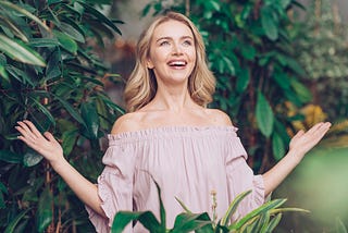 A woman looking at the world with a big smile on her face