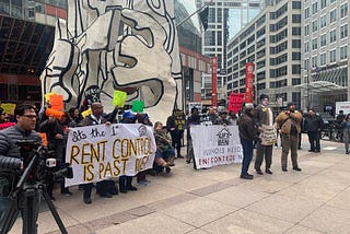 Image of group of people at rally to support rent control