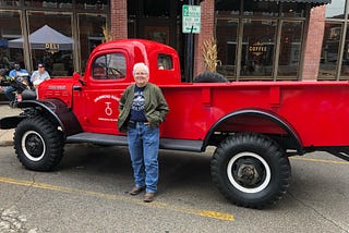 woman stands in front of red truck