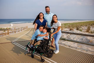 Portrait of family with genetic counselor at the beach