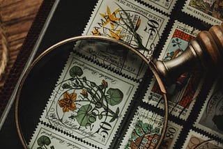 postage stamps and a magnifying glass