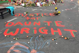 “Justice for Daunte Wright” written in paint on the pavement at George Floyd Square, Minneapolis