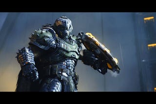 The Doom Slayer poses dramatically with his special shield, which is lined with saw blades and crackling yellow energy bolts.