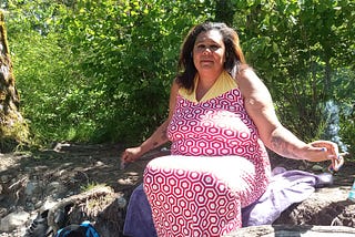 Photo of Devon J Hall showing her body, rolls, saggy breasts, and all