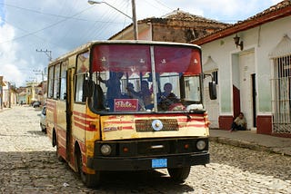 A rickety bus on a cobbled street in Cuba