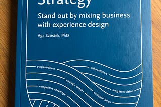 The book “The Umami Strategy: Stand out by mixing business with experience design” laying on a table