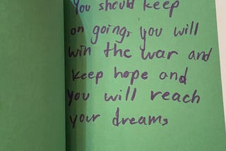 card that reads “You should keep on going, you will win the war and keep home and you will reach your dreams”