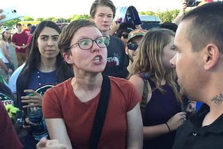 Feminist raging at a man for no reason at a rally.
