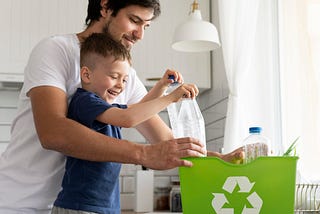a man and his child happily recycling plastic bottles