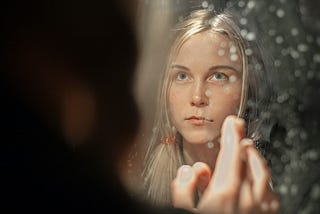 Woman looking at her own reflection.