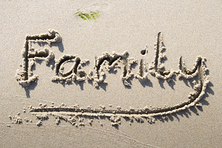 “Family” drawn in the sand.