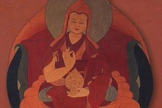 A red-hued painting of the 6th Dalai Lama, holding his hand in a mudra.