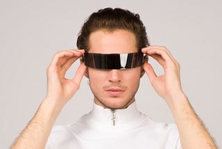 Man wearing white turtle-neck T-shirt looking through a black film.