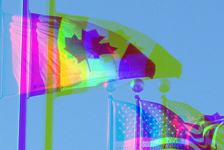 Flags of Canada and the United States of America, flying side-by-side outside PGE Park in Portland, Oregon.