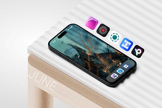 Image of an iPhone 15 Pro on top of a white desk with wooden frame and legs. To the right, it has five icons of iOS, iPadOS and macOS apps. To the side of the table is light white text that is: June.