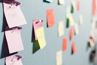 Board with post-it notes. Agile user story board. Corporate social responsibility.