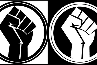 Two Black Power fists. The left fist is black on a white background within a black ring; the right is its inverse.