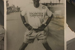 Author on rollerblades as a Cool to be Canadian “Volunteer Floodfighter” (1997) Decades before smartphone coralling and isolation, loss of privacy and autonomy, travel restrictions and the tools in place for global totalitarianism.