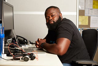 Yao Adantor sitting at a desk. Photo courtesy of MICA Maryland Institute College of Art