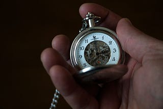 hand holding pocket-clock