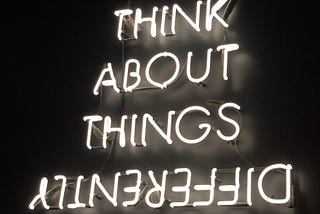 Neon sign that says “Think About Things Differently”