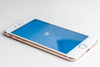 A smartphone with the Twitter logo on the screen.