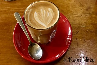 A glass of hot cafe latte on a table