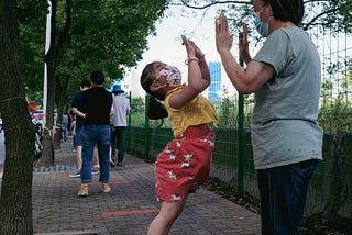 A child jumps up to give her caregiver two high-fives.