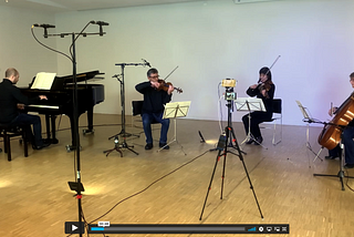 A piano quartet in an unusual setup, all in a semicircle including the piano, which is usually behind