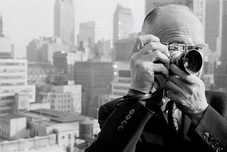 Henri Cartier-Bresson taking a picture from a rooftop.