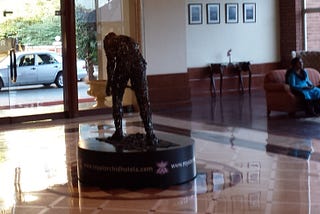 Royal Orchid lobby statue and guest sitting in sofa