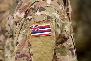 Member wears OCP uniform with state of Hawaii flag