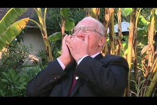 Robert Muller playing the harmonica in the garden