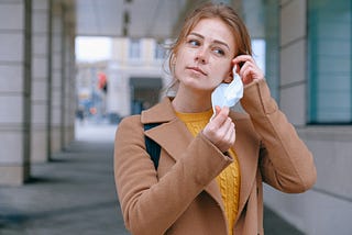 Girl putting on a face mask — Photo by Anna Shvets from Pexels